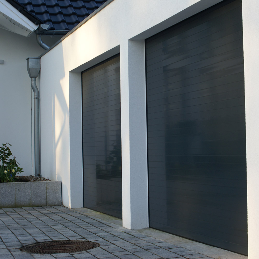 Réparation haut de gamme de porte de garage sectionnelle pour commerces à Noyers.